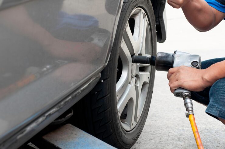 Car Mechanic Removing Bolts Change Tires 1048944 25844117